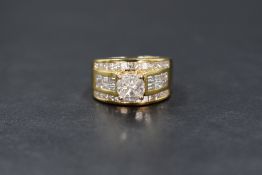 A yellow metal presumed gold diamond set dress ring, the central illusion solitaire comprising