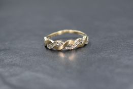 A 9ct gold band ring having open twist detail set with diamond chips, size Q & 1.3g