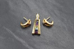 A Guy Laroche diamond and multi-gemstone pendant, the diamond chip set loop having channel set