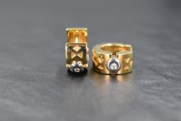 A pair of 18ct gold diamond set hoop earrings, the thick hoops having geometric engraving and a