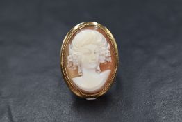 A 9ct gold cameo set ring, the cameo depicting a maiden in a bezel setting, marked 375, ring size O,