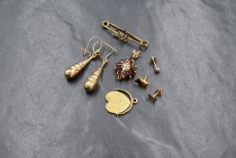 A small selection of yellow metal jewellery including a small bar brooch with seed pearl set swallow