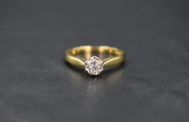Am 18ct gold diamond set solitaire, the round brilliant cut diamond measuring approximately 0.