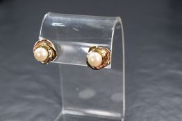 A pair of three tone metal faux pearl set stud earrings, the yellow, white and rose interweaving