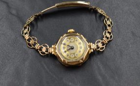 A 9ct gold cased wristwatch, having Arabic numerals, on a rolled gold bracelet strap, marked 375,