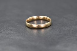 A 9ct gold band, of plain rounded form, marked 375, ring size O-P, 2.1g