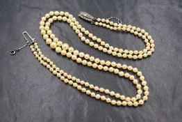 A double row pearl necklace, the graduated pearls having a cream lustre on a marcasite set silver
