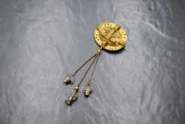An antique yellow metal brooch, of oval form having decorative floral and bead work with three chain