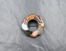 A white metal presumed silver Scottish agate set brooch, the floral motif brooch set with eight