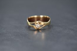 A yellow metal presumed gold diamond solitaire set ring, the round brilliant cut diamond measuring