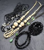 A small selection of beads including a long string of Victorian mourning beads, a ribbon and green