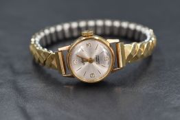 A lady's 1980's 9ct gold wrist watch by Uno having a baton and numeral dial to silvered face in a