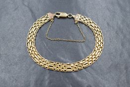 A 9ct gold fancy brick link bracelet, having a lobster clasp and safety chain, marked 375, 10.9g