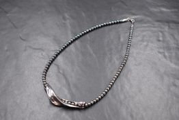 A Georg Jensen silver and hematite beaded necklace, the hematite beads having an organic silver