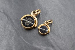 Two yellow metal, presumed gold swivel fobs, both having Agate/Chalcedony discs bearing monograms