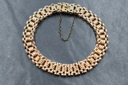 A 10ct gold brick link bracelet, having a box clasp with safety chain, marked 10 to clasp, 19g