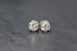 A pair of 18ct white gold diamond solitaire stud earrings, the round brilliant cut diamonds