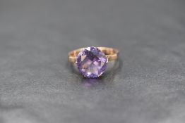 An 18ct gold amethyst set solitaire ring, the round cut amethyst measuring approximately 3.5ct, in