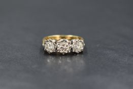 An 18ct gold diamond trilogy ring having three brilliant cut diamonds totalling approx 1ct in an