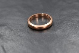 A 9ct rose gold band, of plain rounded form, marked 375, ring size M, 3.6g