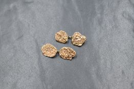 A pair of 9ct gold cufflinks, the panels having an organic 'nugget' motif, marked 9ct, 5.2g