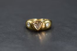 An 18ct gold diamond set gypsy style ring, the central trillion cut diamond in a bezel heart motif