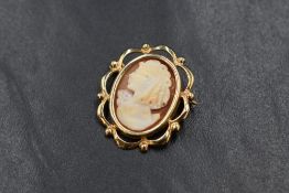 A small 9ct gold mounted cameo brooch depicting a maiden in profile in a decorative mount, approx 4g