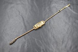 An 18ct gold cased wristwatch, the rectangular dial having Arabic numerals, the case marked 18 .