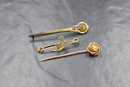 A 9ct gold peridot and seed pearl set brooch, the round cut peridot in a bezel setting, over a split