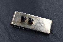 A silver onyx set money clip, of plain rectangular form having two square cut onyx, marked 925, 19.