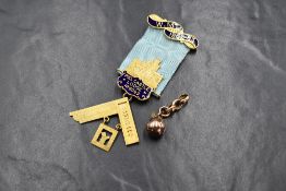 A 9ct gold and enamel Masonic medal, having a gold and enamel bar to the top and a central gold