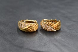 A pair of French 18ct gold diamond set hoop earrings, the hoops having half textured line work and