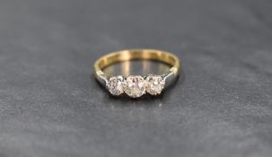 An 18ct gold diamond three stone ring, the central old cut diamond measuring approximately 0.28ct,