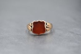 An 8ct rose gold signet ring having a vacant carnelian cartouche in a bezel mount to moulded