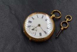 A small continental gold key wound pocket watch stamped 18K having a Roman numeral dial with