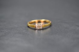 An 18ct gold diamond set solitaire ring, the old cut diamond measuring approximately 0.07ct, in an