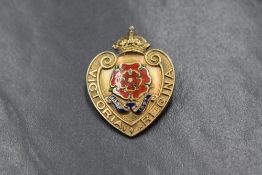 A Victorian 15ct gold heart shaped commemorative brooch having an enamelled old English rose to