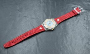 A new in box Swatch Roi Soleil Christmas Special 1993 wristwatch, the blue dial having golden