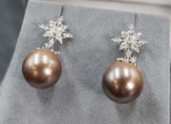 A pair of white metal presumed gold pearl and diamond set drop earrings, the diamond set star