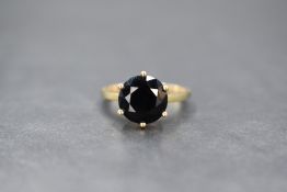 A 9ct gold green sapphire set ring, the round cut sapphire measuring approximately 2.5ct, in a six