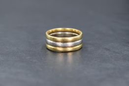A two-tone yellow and white metal band, thought to be 18ct, the central white band flanked by two