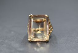 A 9ct gold smoky quartz set dress ring, the emerald cut quartz measuring approximately 19mm x 14mm