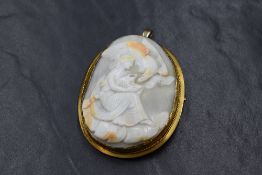 A yellow metal cameo set brooch, the large cameo depicting Hebe goddess of youth or of the prime