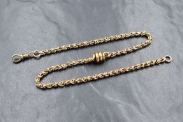 A yellow metal fancy link chain having dog leash clasp and spiral serpent charm, no marks but