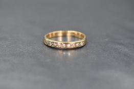 A 9ct gold diamond set band, the band set with 9 round brilliant cut diamonds, marked 375, ring size