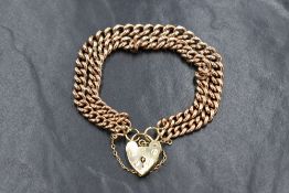 A 9ct rose gold double curb link bracelet with later 9ct gold padlock clasp and safety chain, approx