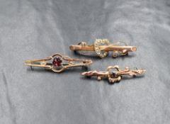 A group of three 9ct gold bar brooches, comprising one having a seed pearl set heart and two
