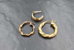 A group of three gold single earrings, comprising an 18ct gold twist hoop, a 9ct gold twist hoop and