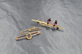A 9ct gold bar brooch having two decorative paste stones set as flower buds, and a yellow metal