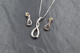 A Hot Diamonds silver pendant with matching earrings, all of a loose twist knot design with inset